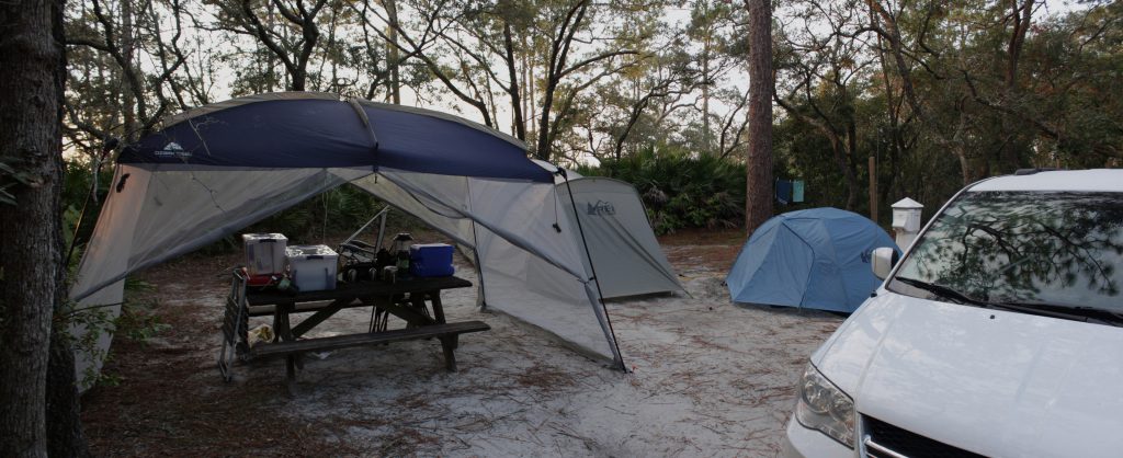 Our camp set up, The sun is just coming up in the east. The river is just behind the bushes at the edge of our camp.