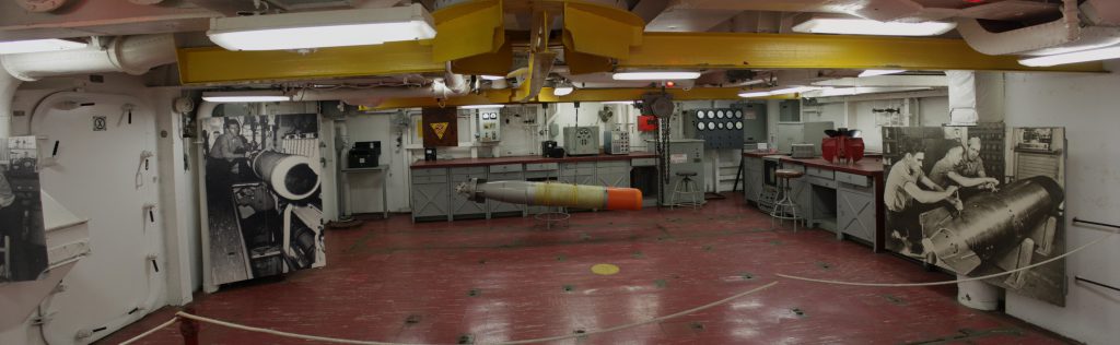 The torpedo bay for preparing torpedoes and sending them out to the plane hangers hung from the (yellow) I-beams.