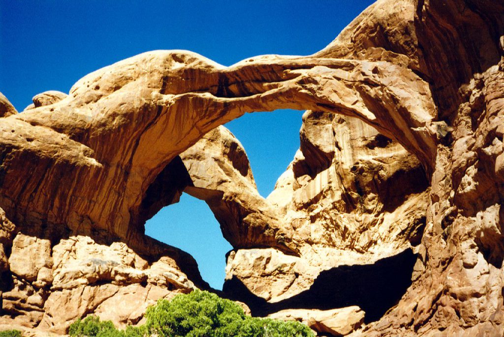 The area around the double arch is quite spectacular -- nearby there are a large number of arches and developing arches. Most of the arches in the park are found in this area and are carved out of the Entrada sandstone layer, which is exposed in this part of the park.