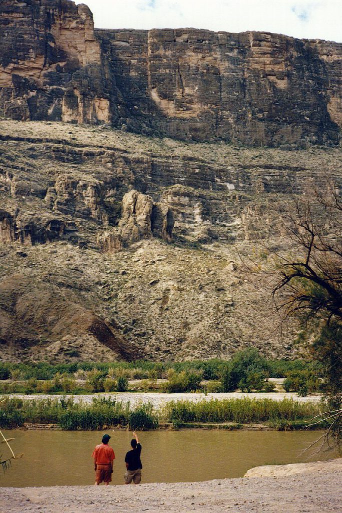 Standing at the eastern edge of the Rio Grande and looking across at the considerable wall opposite on the Mexico side of the river.