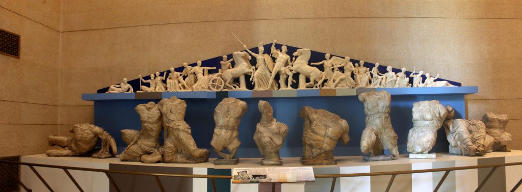 A model of one of the two frieze's adorning the top of the Parthenon. In the foreground are the representations of the classical statues used as the basis.