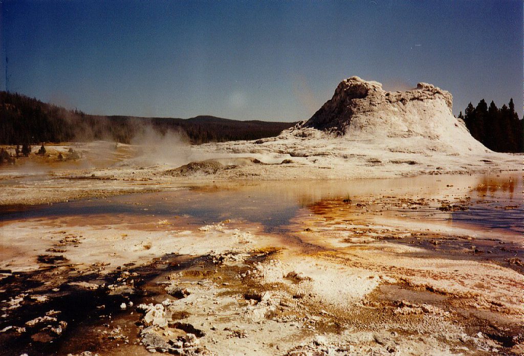 The Castle Geyser and accompanying alga pools in the Geyser Basin. Throughout the Geyser Basin and some other parts of the park you must be careful to walk on provided walkways -- the ground can break and you might find yourself falling into very hot water.